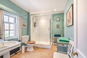 a bathroom with a shower and a toilet and a sink at 1 Bed in Blakeney oc-674 in Blakeney