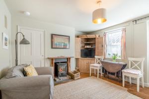 a living room with a couch and a fireplace at 1 Bed in Blakeney oc-674 in Blakeney