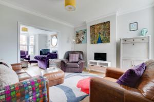 a living room with leather furniture and a tv at 5 Bed in Southwold oc-tlw in Southwold