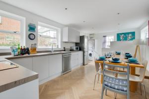 a kitchen with a table with blue dishes on it at 5 Bed in Southwold oc-tlw in Southwold