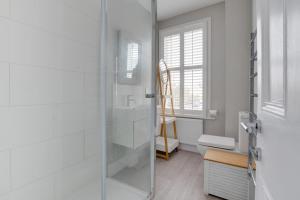 a bathroom with a glass shower and a toilet at 5 Bed in Southwold oc-tlw in Southwold +16 photos