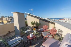 a group of chairs and tables on a balcony at La Dimora dei WaLori in Bisceglie
