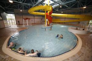 a group of people in an indoor swimming pool at M6 Mallard Rise in Goodrington