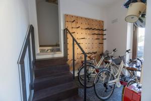 a group of bikes parked in a room with stairs at La Dimora dei WaLori in Bisceglie