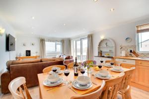 a kitchen and living room with a table and chairs at 3 Bed in Abersoch oc-kook72 in Abersoch