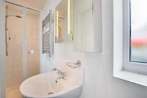 a white bathroom with a sink and a window at 3 Bed in Abersoch oc-kook72 in Abersoch +7 photos