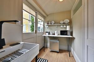 a small kitchen with a sink and a microwave at Finest Retreats - St Germains Annexe in Sandwich