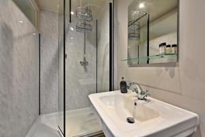 a white bathroom with a sink and a shower at Finest Retreats - St Germains Annexe in Sandwich +12 photos