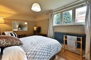 a bedroom with a bed and two windows at Finest Retreats - St Germains Annexe in Sandwich