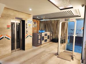 a room with an open door to a room with at Hotel HSP Suites - Near IGI Airport, New Delhi in New Delhi