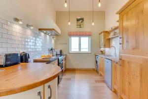 a large kitchen with a wooden counter top at 1 Bed in Beckley oc-rh1151 in Beckley +6 photos