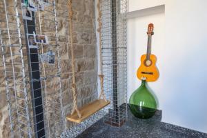 a green glass bottle sitting on a counter next to a guitar at La Dimora dei WaLori in Bisceglie +40 photos