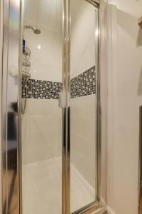 a shower with a glass door in a bathroom at 3 Bed in Cley oc-2122 in Cley next the Sea