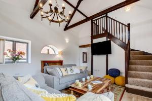 a living room with a couch and a staircase at 3 Bed in Shereford oc-2173 in Tatterford
