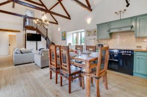 a kitchen and living room with a table and chairs at 3 Bed in Shereford oc-2173 in Tatterford