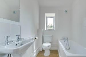 a white bathroom with a sink and a toilet at 3 Bed in Shereford oc-2173 in Tatterford +10 photos