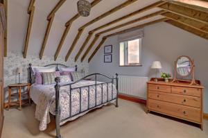 a bedroom with a bed and a dresser and a mirror at 2 Bed in Field Dalling oc-1643 in Saxlingham +2 photos