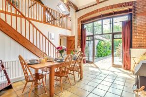 a dining room with a wooden table and chairs at 3 Bed in Sustead oc-1880 in Felbrigg