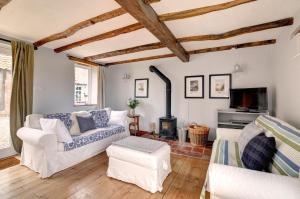 a living room with white furniture and a fireplace at 2 Bed in Field Dalling oc-1643 in Saxlingham