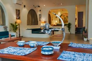 a table with a metal statue of a woman on it at Zoe Cozy Escape with Big Projector in Amritsar