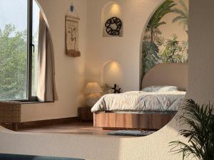 a bedroom with a bed and a large window at Zoe Cozy Escape with Big Projector in Amritsar