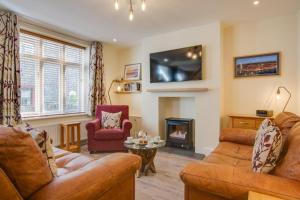 a living room with two couches and a fireplace at 3 Bed in Sheringham oc-2170 in Sheringham