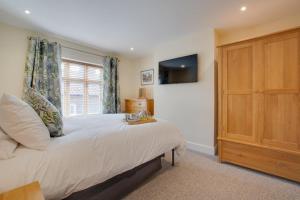 a bedroom with a large bed and a window at 3 Bed in Sheringham oc-2170 in Sheringham