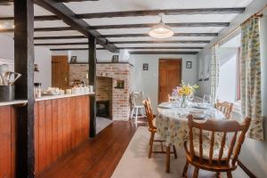 a dining room with a table and a fireplace at 2 Bed in Swimbridge oc-n0209 in Swimbridge
