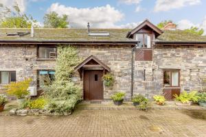 an old stone house with a wooden door at 2 Bed in Swimbridge oc-n0209 in Swimbridge