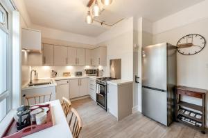 a kitchen with a table and a refrigerator at 3 Bed in Woolacombe oc-n1711 in Woolacombe