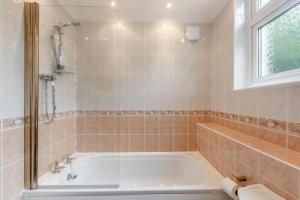 a bathroom with a tub and a window at 3 Bed in Woolacombe oc-n1711 in Woolacombe