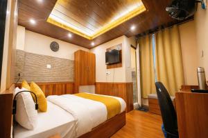 a bedroom with a bed and a television in it at Hotel Ambrosia in Gangtok +21 photos