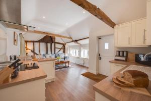 a kitchen with white cabinets and a counter top at 1 Bed in Saxtead oc-sfmhf in Saxtead