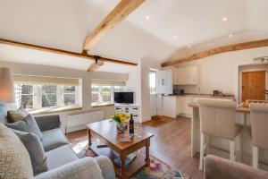 a living room with a couch and a table at 1 Bed in Saxtead oc-sfmhf in Saxtead