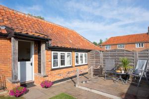 a brick house with a patio and a fence at 1 Bed in Saxtead oc-sfmhf in Saxtead +14 photos