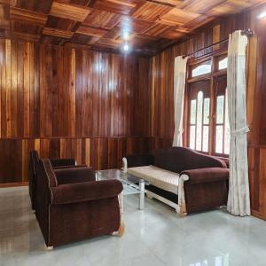 a living room with a couch and a chair at DalatXCamp Nystay in Ấp Kim Thạch