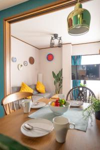 a dining room table with a bowl of fruit on it at cozy 3rd stay in Okayama