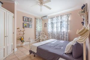 a bedroom with a bed and a ceiling fan at Los Balcones, Sosua, Ocean Front! in Sosúa +9 photos