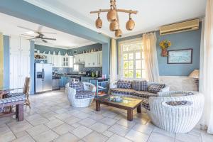 a living room with couches and a table at Los Balcones, Sosua, Ocean Front! in Sosúa