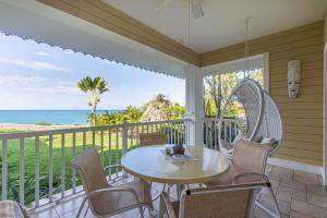 a porch with a table and chairs and the ocean at Los Balcones, Sosua, Ocean Front! in Sosúa