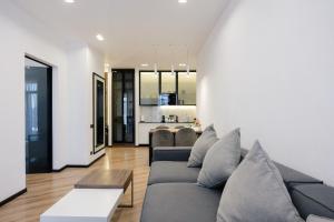 a living room with a couch and a table at Mountain Residence Apartments & Chalet in Bukovel
