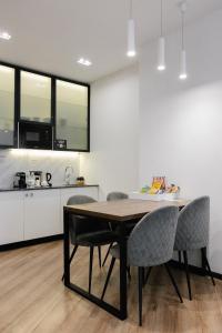 a kitchen and dining room with a table and chairs at Mountain Residence Apartments & Chalet in Bukovel