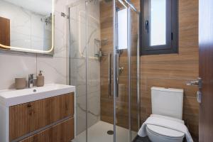 a bathroom with a toilet and a glass shower at Hinoki 2-Bedroom Apartment in Larnaca +12 photos