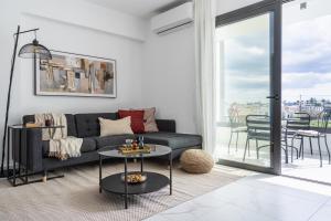 a living room with a couch and a table at Hinoki 2-Bedroom Apartment in Larnaca