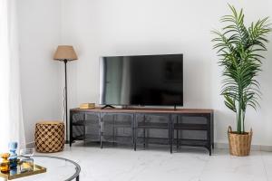 a living room with a television on a dresser at Hinoki 2-Bedroom Apartment in Larnaca