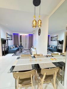 a dining room and living room with a table and chairs at KLCC Marc Residence by AZ Line in Kuala Lumpur
