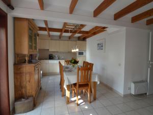 a kitchen with a table and chairs in a room at Cosy fisherman s house ideally located for coastal walking and cycling tours in De Haan