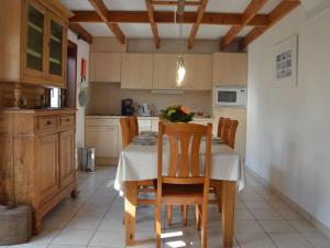 a kitchen with a table and chairs in a room at Cosy fisherman s house ideally located for coastal walking and cycling tours in De Haan