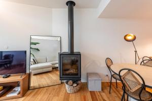 a living room with a fireplace and a couch at Foz Velha River House in Porto