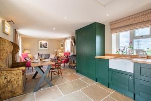 a kitchen with green cabinets and a table at 1 Bed in Brassington oc-dcneb in Brassington
